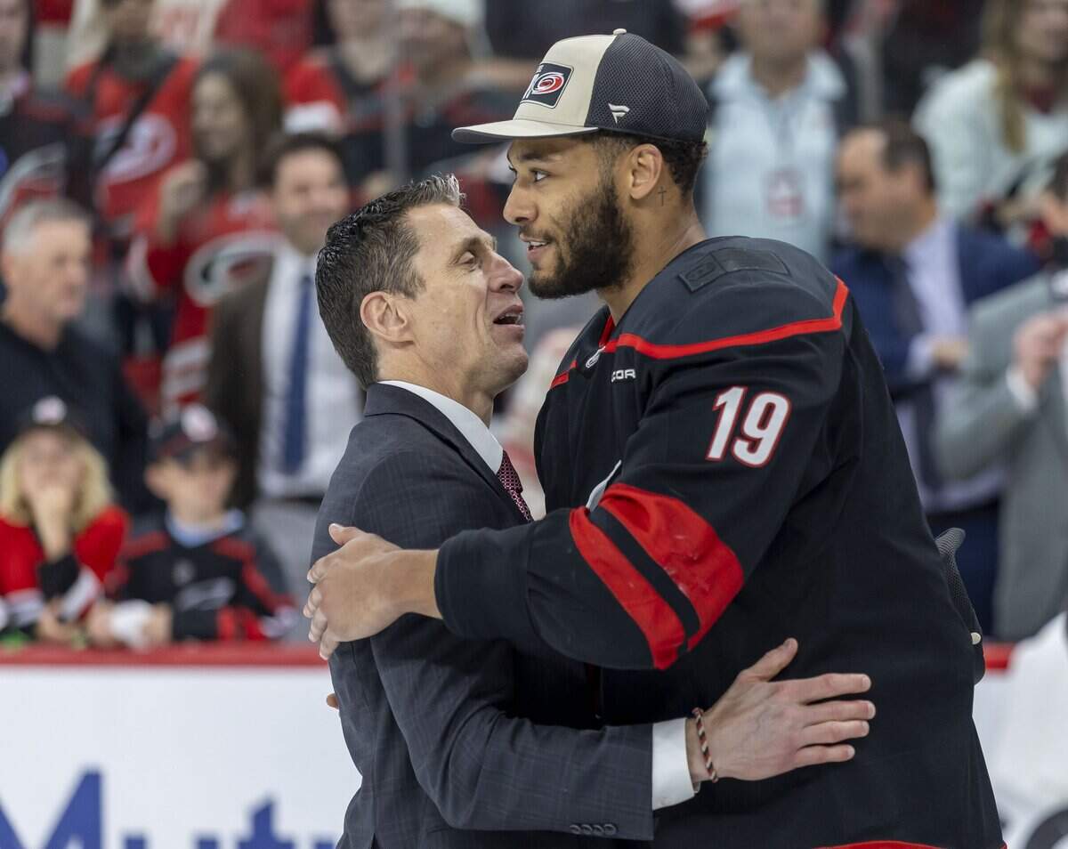 Carolina Hurricanes head coach Rod Brind’Amour embraces defenseman K’Andre Miller (19) following their 6-1 victory over Montreal, clinching the Eastern Conference, and advancing to the Stanley Cup Finals on Friday, May 29, 2026 at Lenovo Center in Raleigh, N.C.