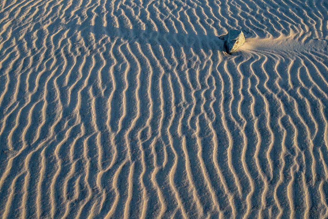 The morning sun illuminates the sand dunes along NC 12 at the Oregon Inlet Life-Saving Station on Wednesday, June 30, 2021 in Rodanthe, N.C.