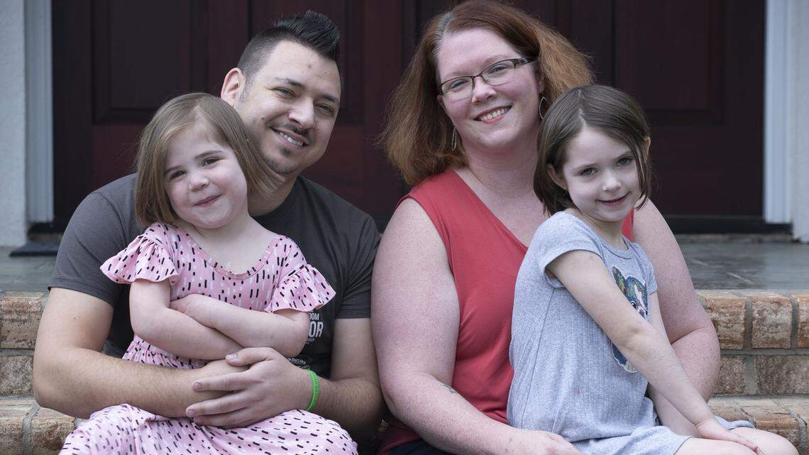 Three-year-old Naomi Reeves poses for a family portrait with her sister Kathryn Reeves, age 6, mother Bethany Erin Reeves, and father Jared Reeves on Saturday, March 14, 2020 in Raleigh, N.C. Due to Naomi’s compromised immune system, Bethany is limiting Naomi’s social interaction during the spread of the COVID-19 virus.