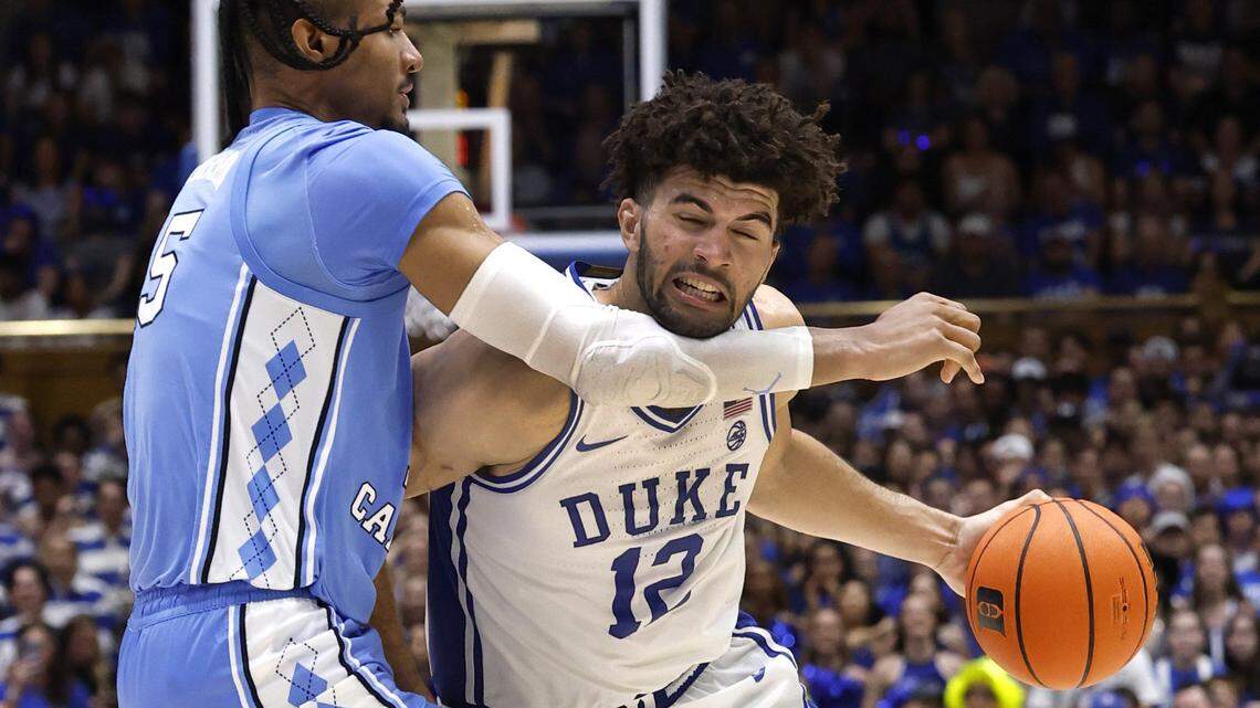 Duke’s Cameron Boozer (12) drives around North Carolina's Jarin Stevenson (15) during the second half of Duke’s 76-61 victory over UNC at Cameron Indoor Stadium in Durham, N.C., Saturday, March 7, 2026.