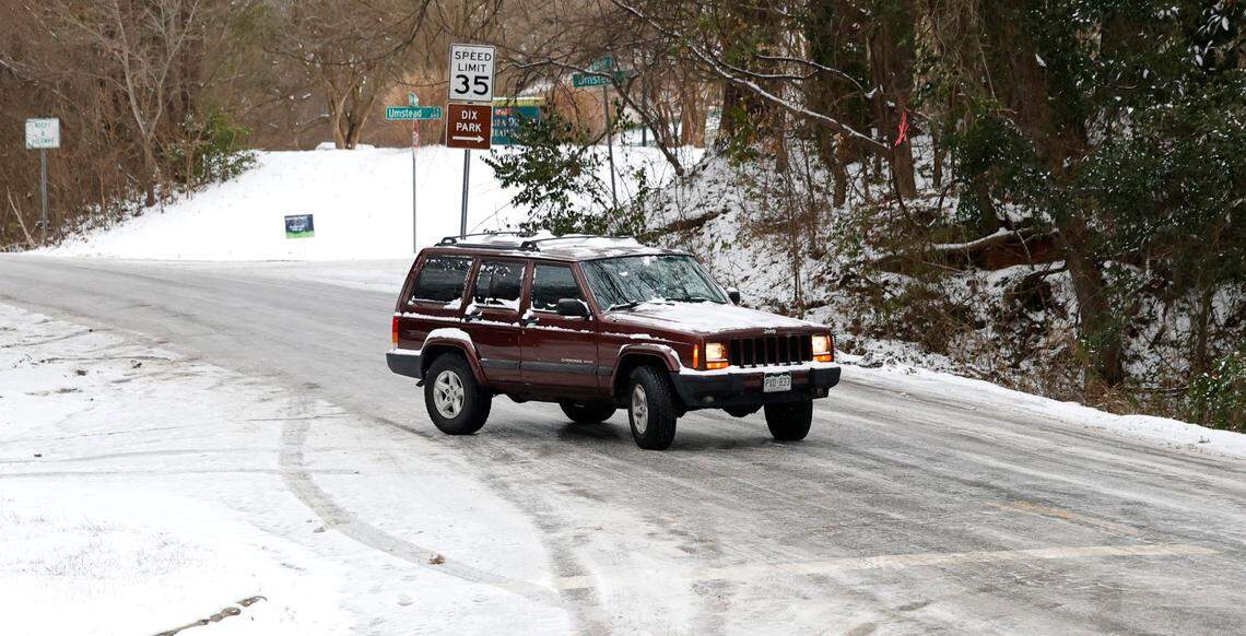 A vehicle slides down an icy Lake Wheeler Road by S. Saunders Street in Raleigh Thursday morning, Feb. 20, 2025.