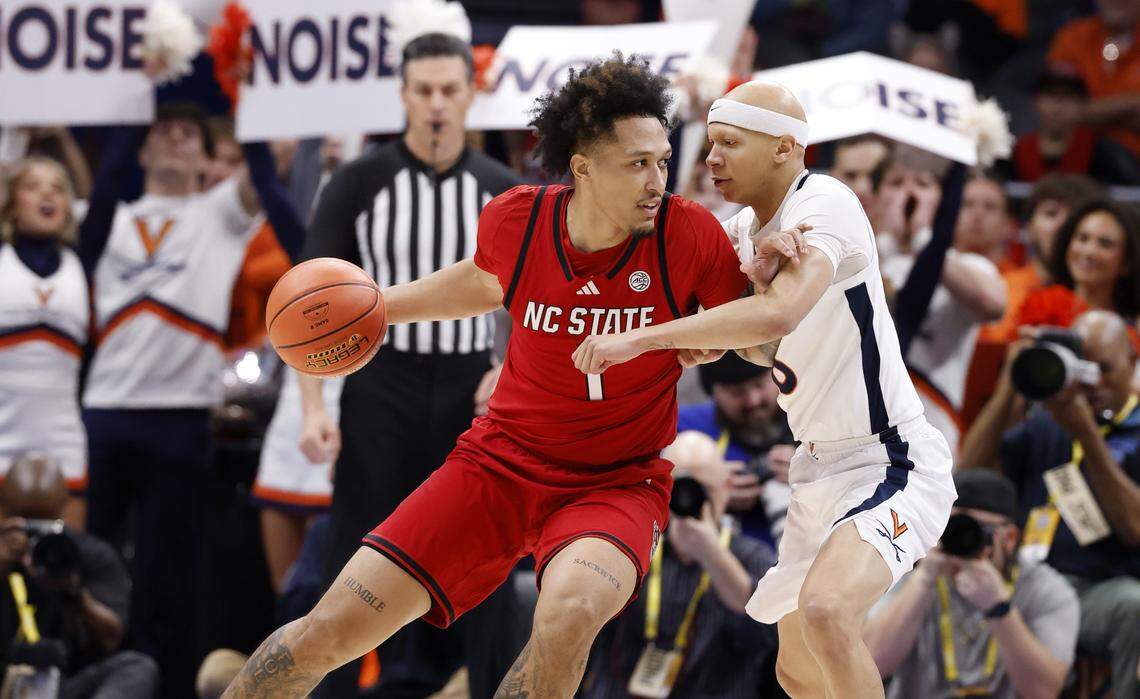 N.C. State's Darrion Williams (1) looks for room as Virginia's Jacari White (6) defends during the first half of N.C. State’s game against Virginia in the quarterfinals of the 2026 ACC Men’s Basketball Tournament at the Spectrum Center in Charlotte, N.C., Thursday, March 12, 2026.