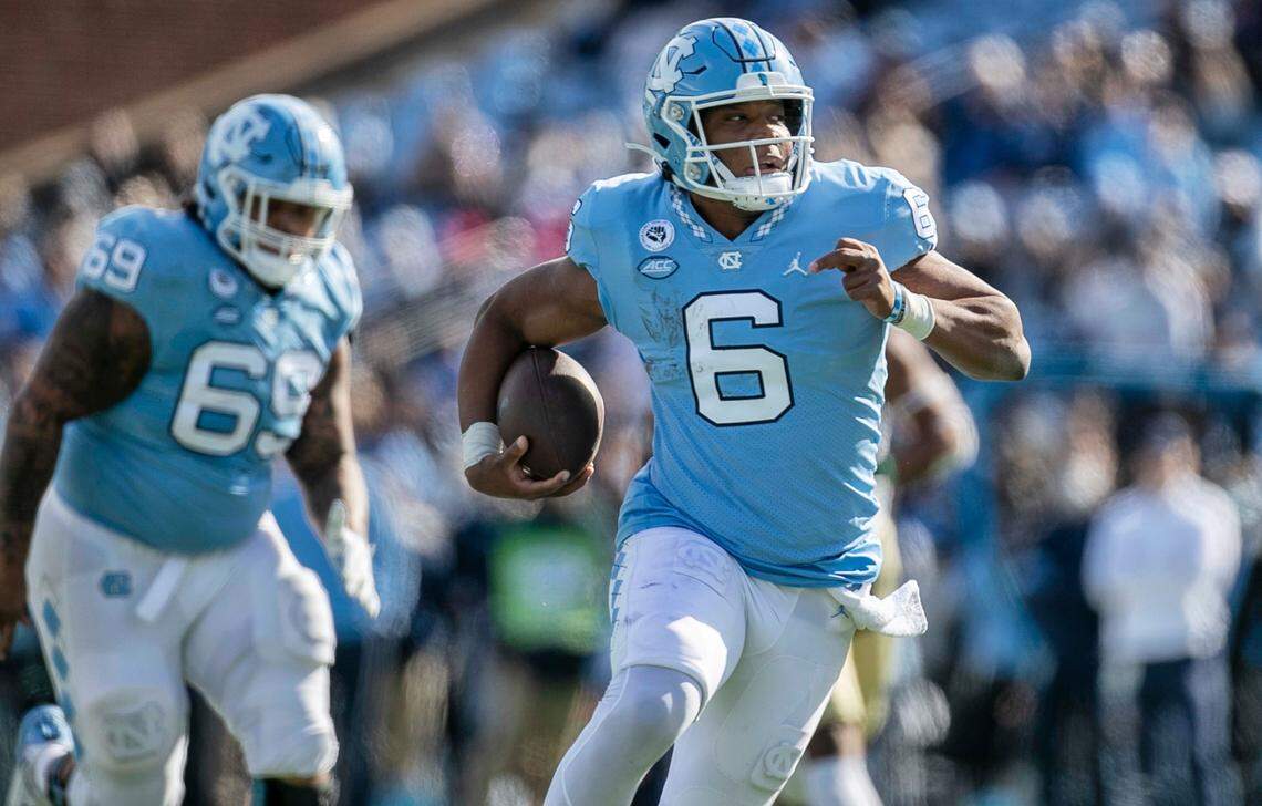 North Carolina quarterback Jacolby Criswell (6) breaks open for a 26-yard run in the first quarter to set up the Tar Heels’ first touchdown against Wofford on Saturday, November 20, 2021 at Kenan Stadium in Chapel Hill, N.C.