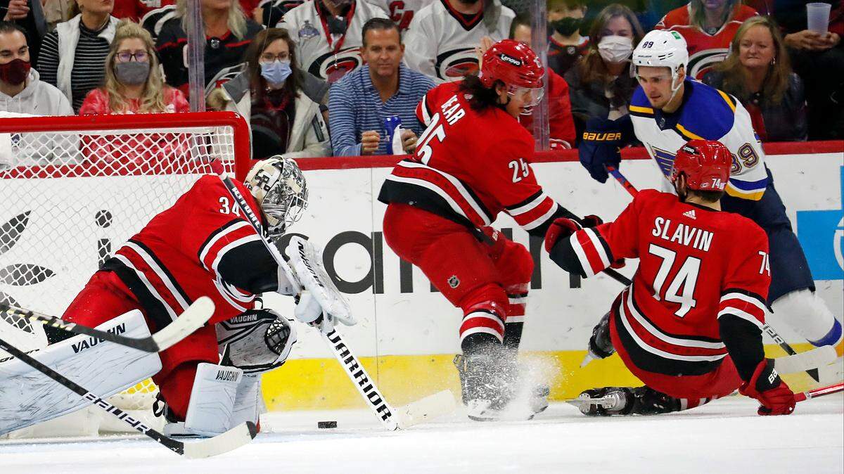 Carolina Hurricanes goaltender Alex Lyon (34) freezes the puck as teammates Ethan Bear (25) and Jaccob Slavin (74) defends against St. Louis Blues’ Pavel Buchnevich (89) during the second period of an NHL hockey game in Raleigh, N.C., Saturday, Nov. 13, 2021. (AP Photo/Karl B DeBlaker)