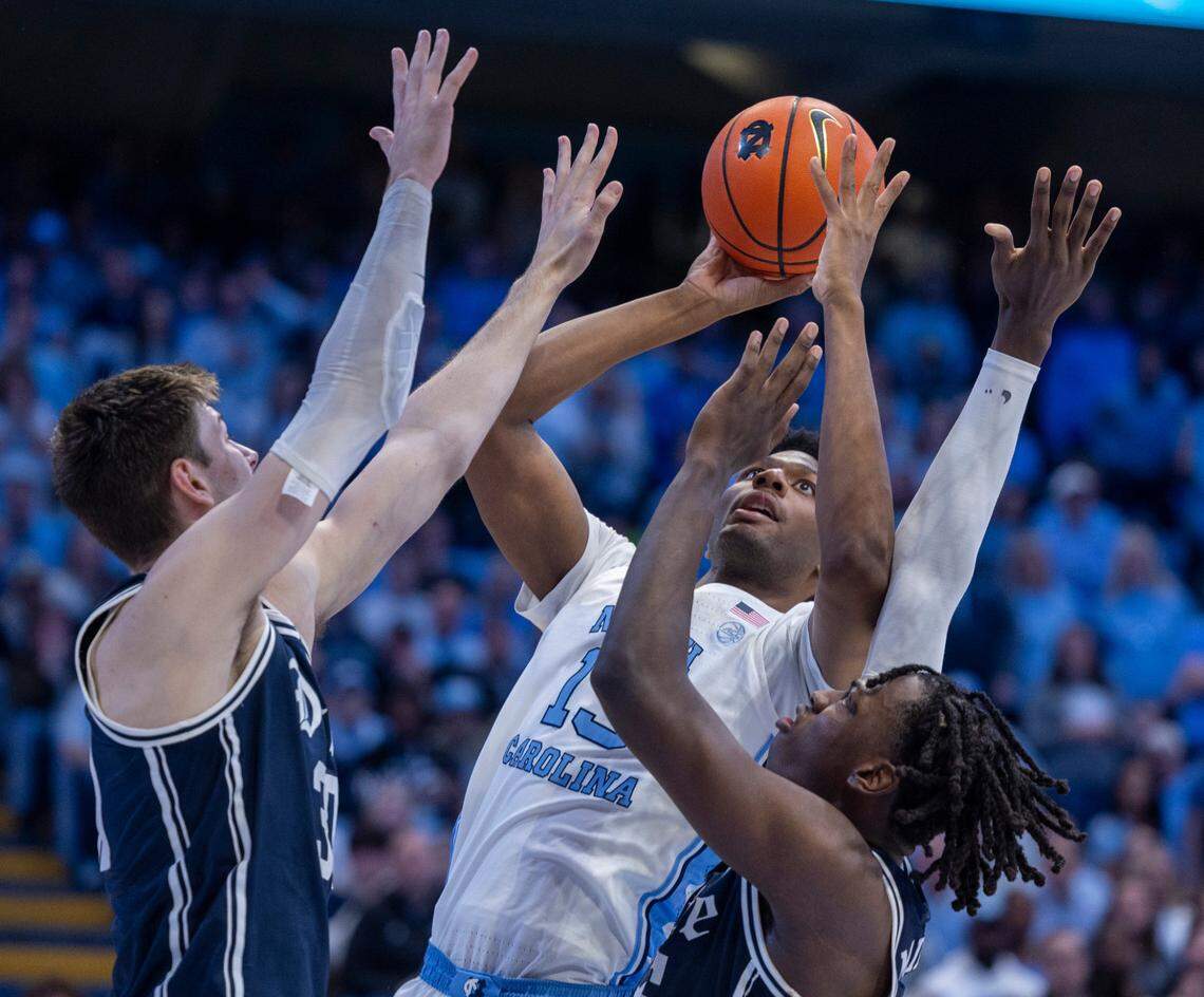 North Carolina’s Jalen Washington (13) works his way to the basket against Duke’s Kyle Filipowski (30) and Mark Mitchell (25) in the second half on Saturday, February, 3, 2024 at the Dean E. Smith Center in Chapel Hill, N.C.