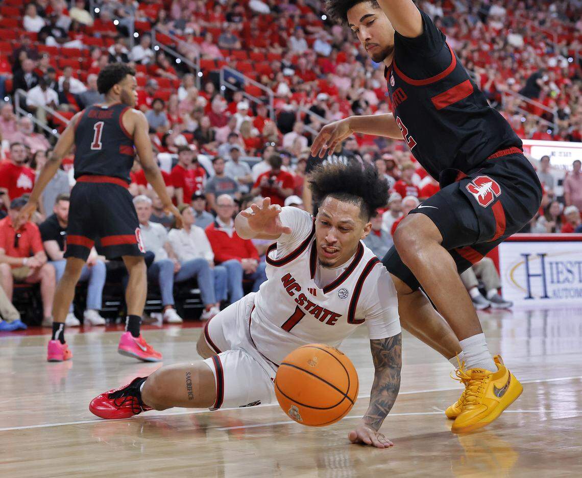 N.C. State's Darrion Williams turns the ball over under pressure from Stanford's Donavin Young during the second half of the Wolfpack’s 85-84 loss on Saturday, March 7, 2026, at Lenovo Center in Raleigh, N.C.