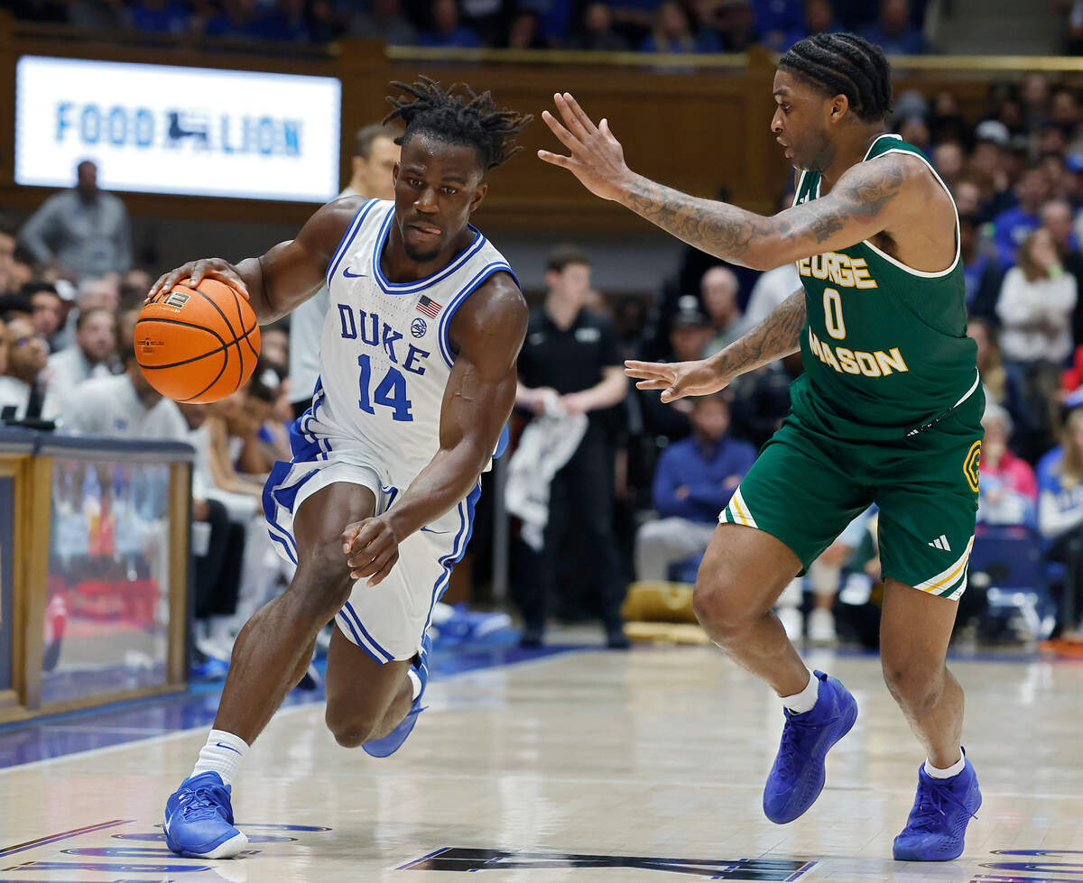 Duke’s Sion James pushes the ball past George Mason’s K.D. Johnson during the first half of the Blue Devils’ 68-47 win on Tuesday, Dec. 17, 2024, at Cameron Indoor Stadium in Durham, N.C.