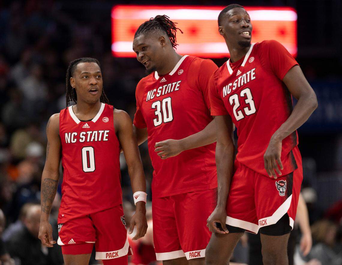 N.C. State’s D.J. Horne (0), D.J. Burns Jr. (30) and Mohamed Diarra (23) confer coming out of a time out in the second half against Syracuse during the ACC Men’s Basketball Tournament at Capitol One Arena on Wednesday, March 13, 2024 in Washington, D.C.