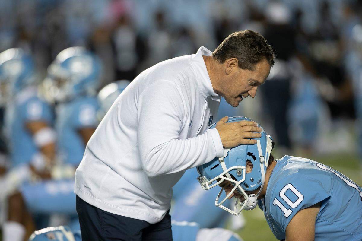 North Carolina defensive coach Gene Chizik talks with North Carolina quarterback Drake Maye (10) prior to the Tar Heels’ game against Pitt on Saturday, October 29, 2022 at Kenan Stadium in Chapel Hill, N.C.