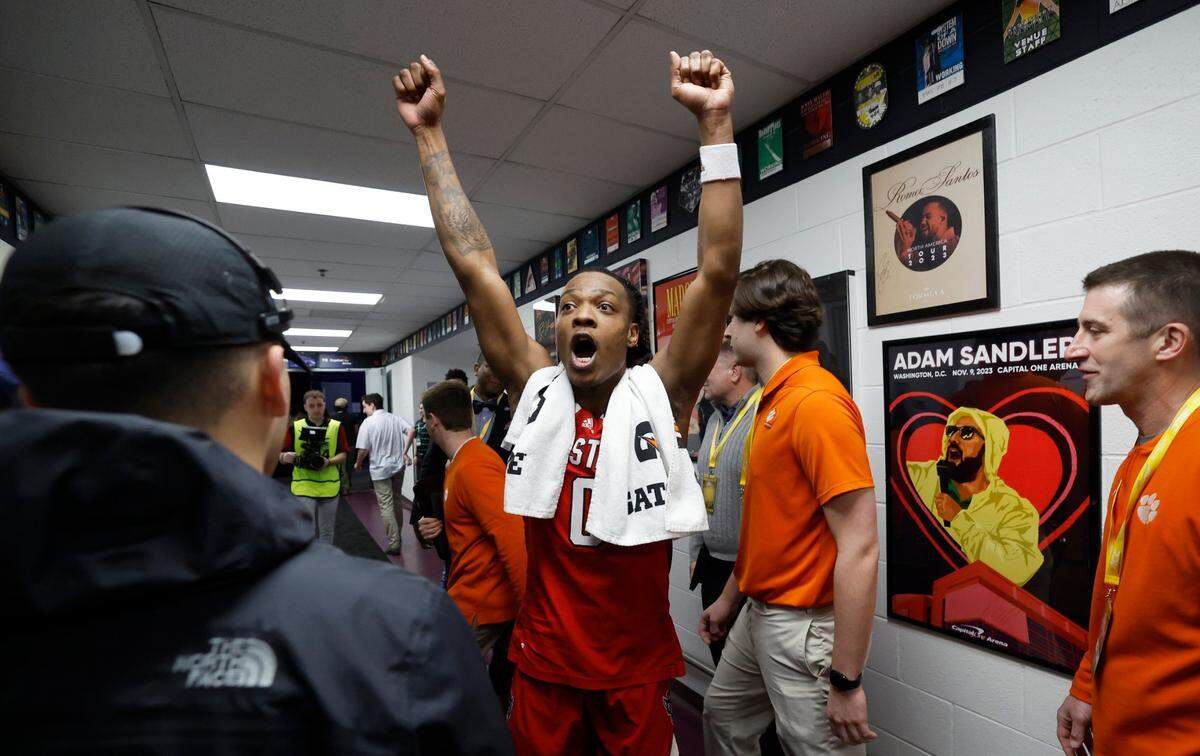 N.C. State’s DJ Horne (0) reacts as he sees the Wolfpack’s sticker on a board showing they advanced after N.C. State’s 83-65 victory over Syracuse in the second round of the 2024 ACC Men’s Basketball Tournament at Capital One Arena in Washington, D.C., Wednesday, March 13, 2024.