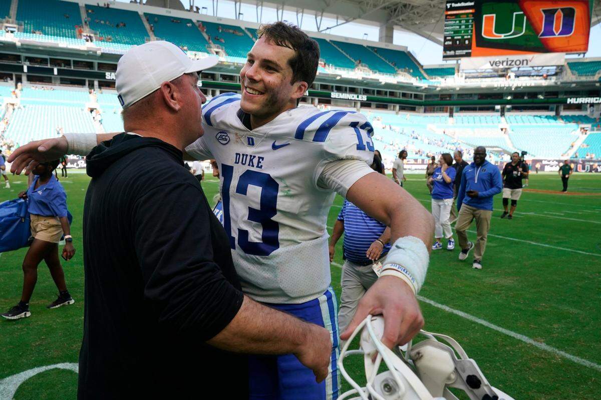 Duke head coach Mike Elko and quarterback Riley Leonard (13) congratulate each other after Duke beat Miami 45-21, in an NCAA college football game, Saturday, Oct. 22, 2022, in Miami Gardens.