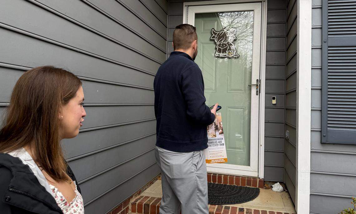 Americans for Prosperity Action Senior Advisor Tyler Voigt and Meghan Winston knock on a door in Charlotte to ask residents to vote for Michael Whatley for U.S. Senate.