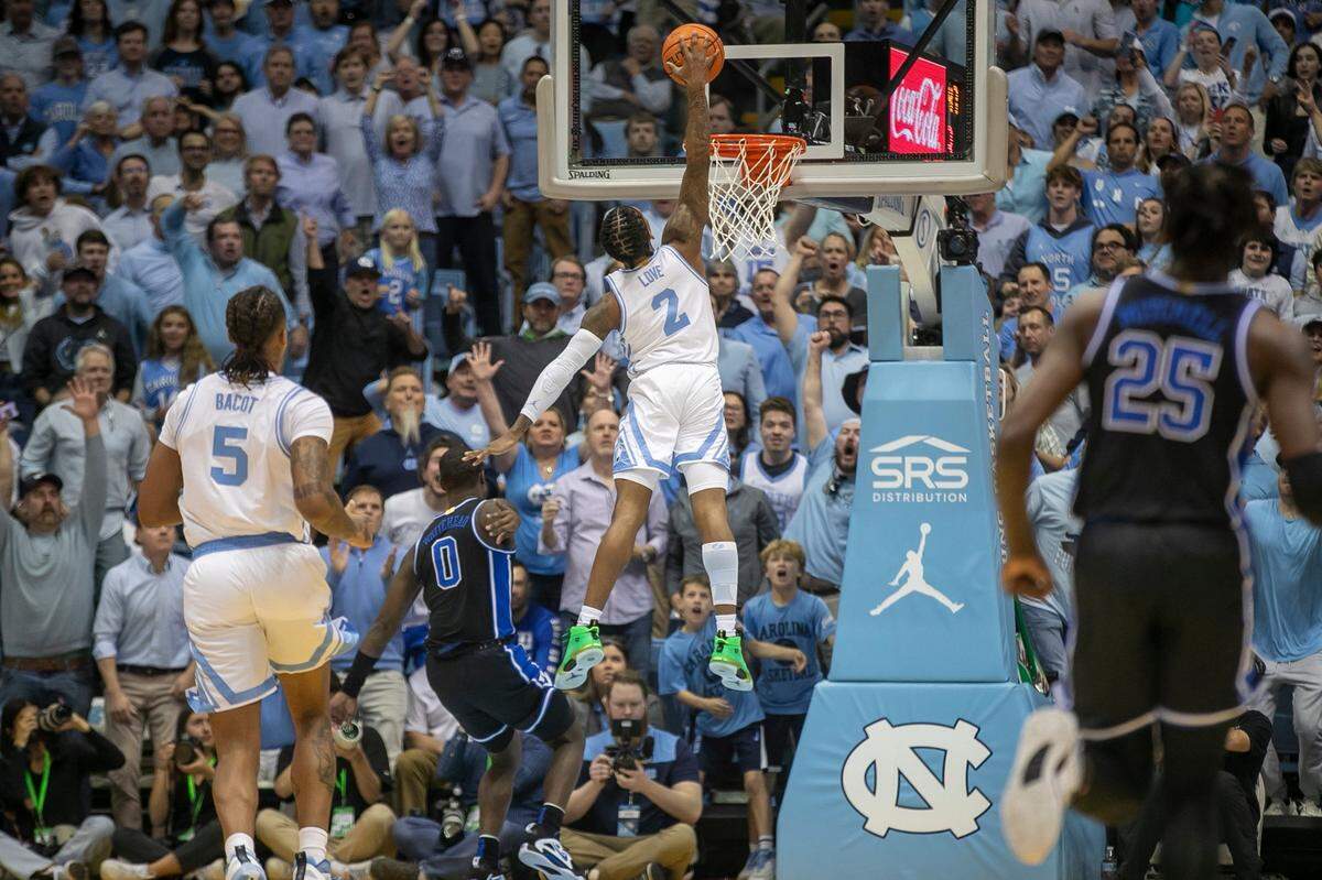North Carolina’s Caleb Love (2) soars to the basket for a dunk against Duke during the first half on Saturday, March 4, 2023 at the Smith Center in Chapel Hill, N.C.