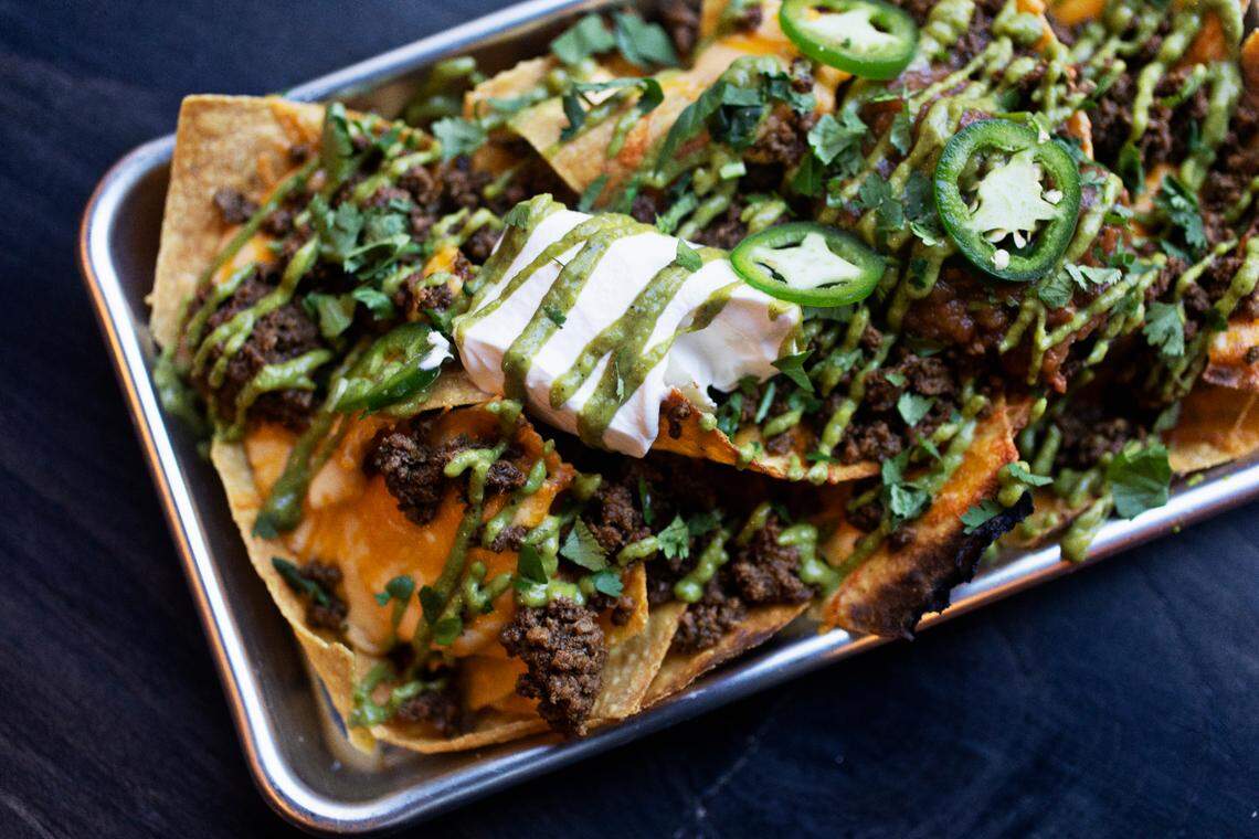 Queeny’s in downtown Durham includes a menu inspired by neighborhood bar and grills with menu items like these sheet pan nachos.