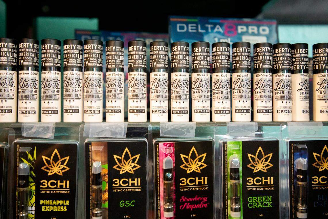 Vape cartridges of Delta 8 THC are displayed on shelves at a Cannabliss dispensary..
