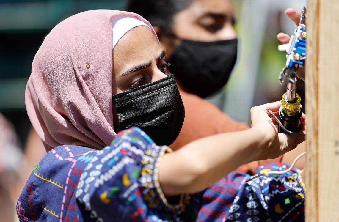 Mannal Amjad, a rising senior at Panther Creek High School, works on wiring a light switch during Construction Field Day at Bobbitt Design Build in Raleigh, N.C., Tuesday, July 19, 2022. The field day is part of WakeEd Partnership and Wake County Schools’ Career Accelerator, a two-week program to give students an opportunity for workplace learning experiences.