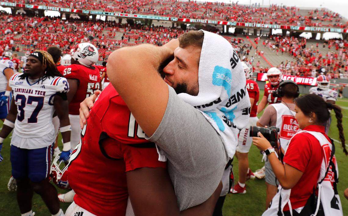 N.C. State quarterback Grayson McCall (2) hugs quarterback CJ Bailey (16) after the Wolfpack’s 30-20 victory over LA Tech at Carter-Finley Stadium in Raleigh, N.C., Saturday, Sept. 14, 2024.