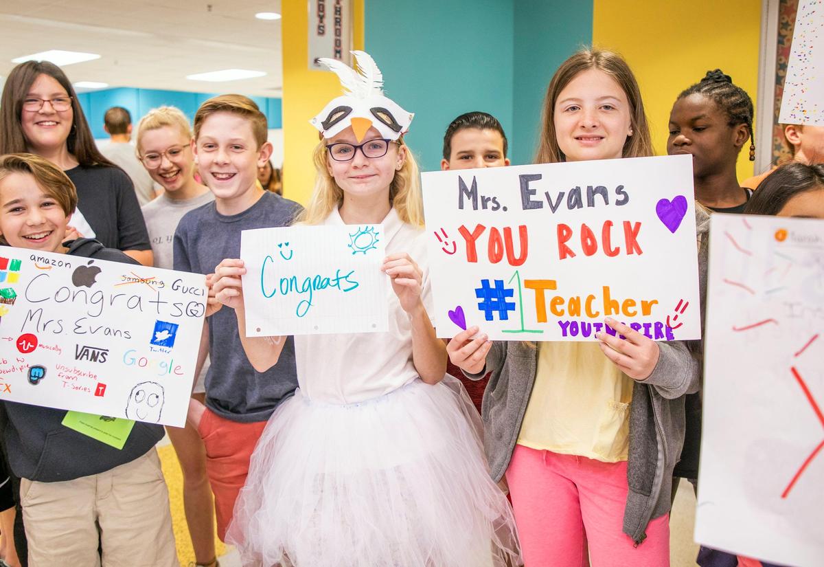 Students at Apex Friendship Middle School hold signs to congratulate Lindsey Evans, an 8th-grade social studies teacher who was named Wake County’s 2019-20 Teacher of the Year, on Friday, May 10, 2019, in Apex, NC.