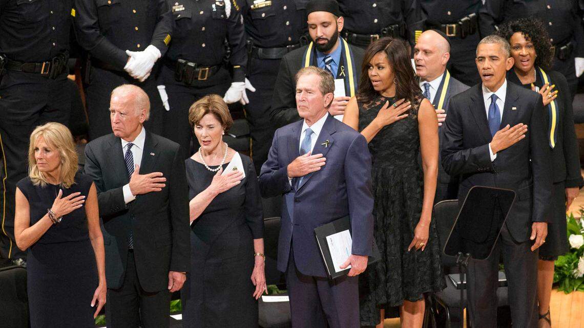 President Barack Obama, First Lady Michelle Obama, President George Bush, former first lady Laura Bush, Vice President Joe Biden, and Jill Biden stand during the interfaith memorial service for the slain Dallas officers at the Morton H. Meyerson Symphony Center.