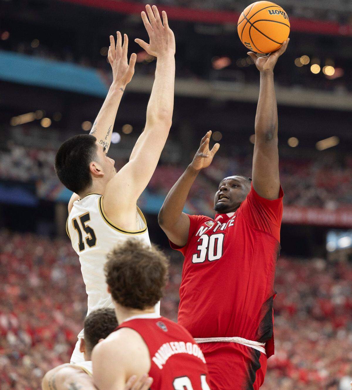 N.C. State’s D.J. Burns Jr. (30) puts up a shot against Purdue’s Zach Edey (15) during the first half in the NCAA Final Four National Semifinal game on Saturday, April 6, 2024 at State Farm Stadium in Glendale, AZ.