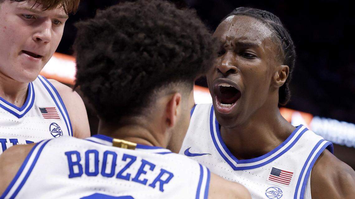 Duke’s Dame Sarr (7) and Nikolas Khamenia (14) celebrate with Cayden Boozer (2) after he made’the basket while being fouled in the second half DukeÕs 80-79 victory over Florida State in the quarterfinals of the 2026 ACC MenÕs Basketball Tournament at the Spectrum Center in Charlotte, N.C., Thursday, March 12, 2026.