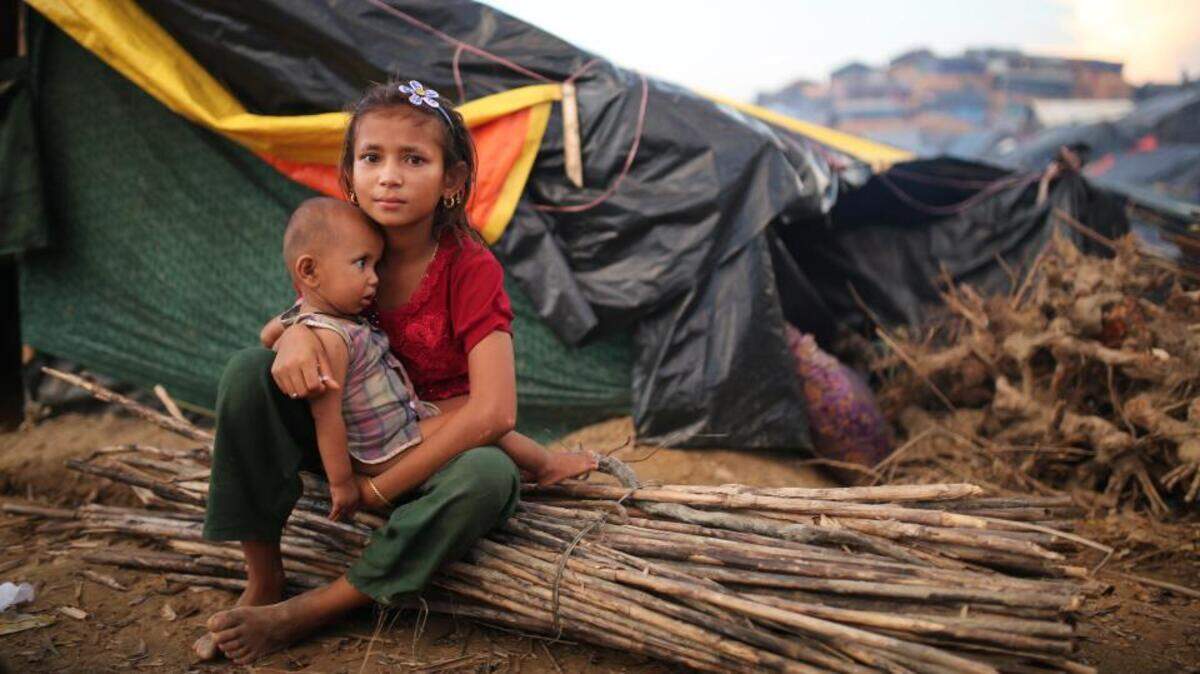 A Rohingya girl fled her home carries a child and rests at Palangkhali refugee camp in Cox's Bazar, Bangladesh, October 4, 2017. (Photo AP) (AP)