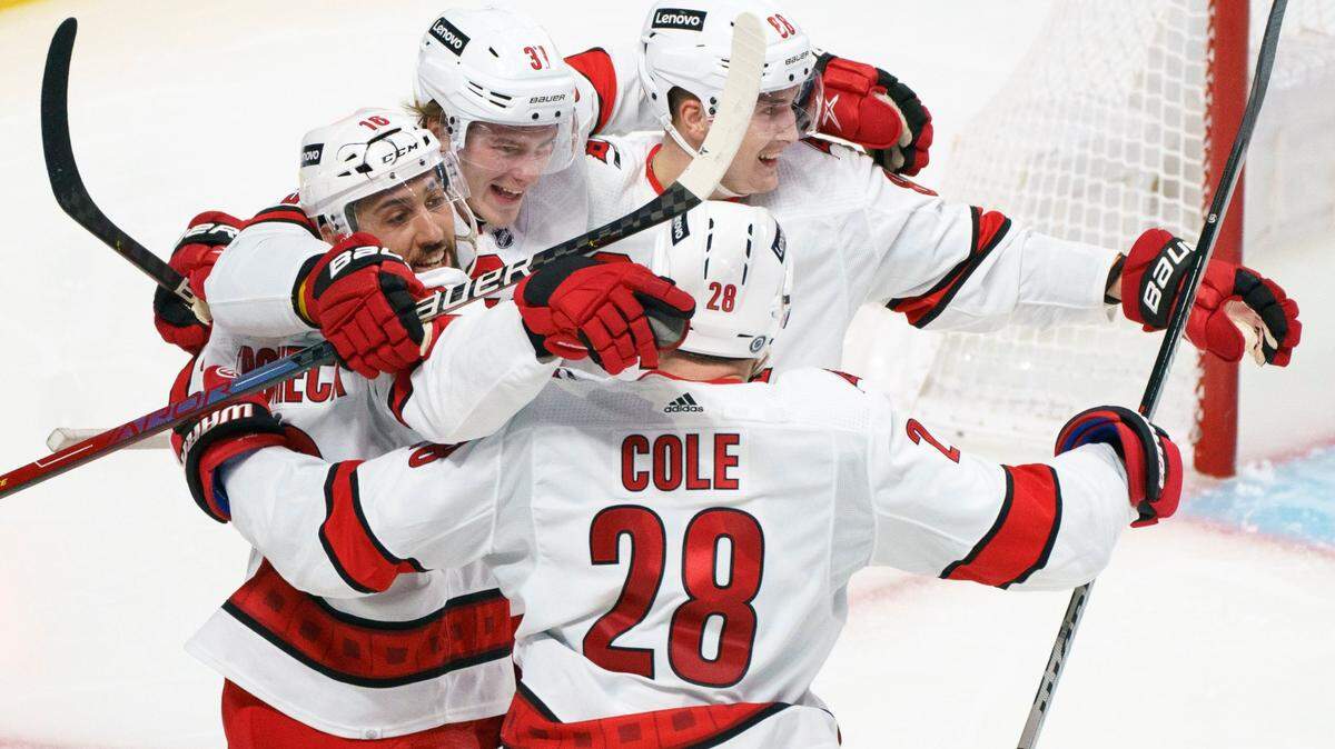 Carolina Hurricanes’ Andrei Svechnikov (37) celebrates his goal against the Montreal Canadiens with Vincent Trocheck, left, Martin Necas, right, and Ian Cole during the second period of an NHL hockey game Thursday, Oct. 21, 2021, in Montreal. (Paul Chiasson/The Canadian Press via AP)