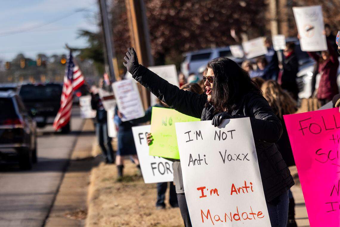 Demonstrators opposed to vaccine requirements protest outside the The N.C. Commission for Public Health in Raleigh Wednesday, Feb. 2, 2022. The commission unanimously voted against a rule-making petition from four UNC System professors to add the COVID vaccine to state immunization requirements for people who are 17 years old or who are entering 12th grade as of July 1.