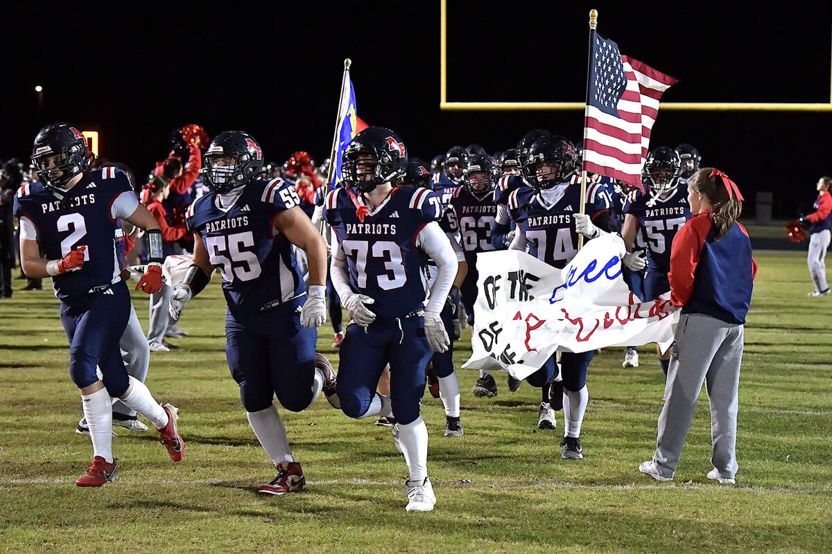 Apex-Friendship offensive lineman Nolan Bennett (73) and teammates run onto the field before their playoff game against Rolesville. The Apex Friendship Patriots and the Rolesville Rams met in  the second round of the  NCHSAA 8A Playoff game in Apex, N.C. on November 14, 2025. Rolesville wins 14-7 in overtime.