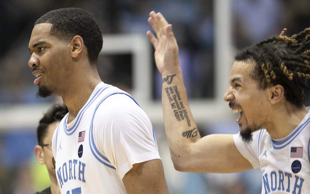 North Carolina’s Cole Anthony (2) and Garrison Brooks (15) celebrate the Tar Heels’ 85-79 victory over N.C. State on Tuesday, February 25, 2020 at the Smith Center in Chapel Hill, N.C.