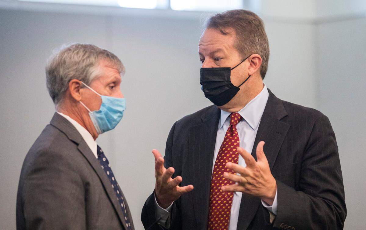 Juul attorney Andrew McGann, right, and Andy Penry, left, an attorney for the state, converse before a hearing regarding the state’s case against the e-cigarette company on Monday, June 28, 2021 at the Durham County Courthouse.