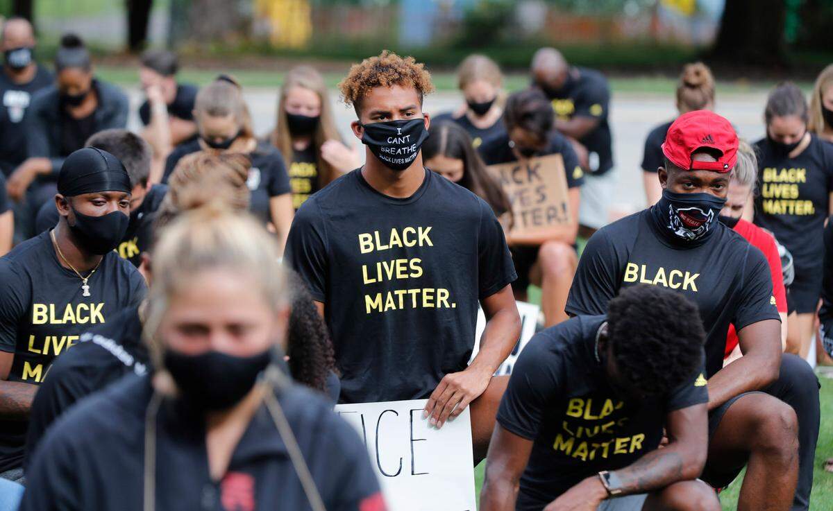 N.C. State athletes, coaches and staff kneel for 8:46, the time police kneeled on George Floyd, during a #PackUnited peaceful protest against racial and social injustice outside Holladay Hall on the campus of N.C. State Saturday, Sept. 12, 2020.