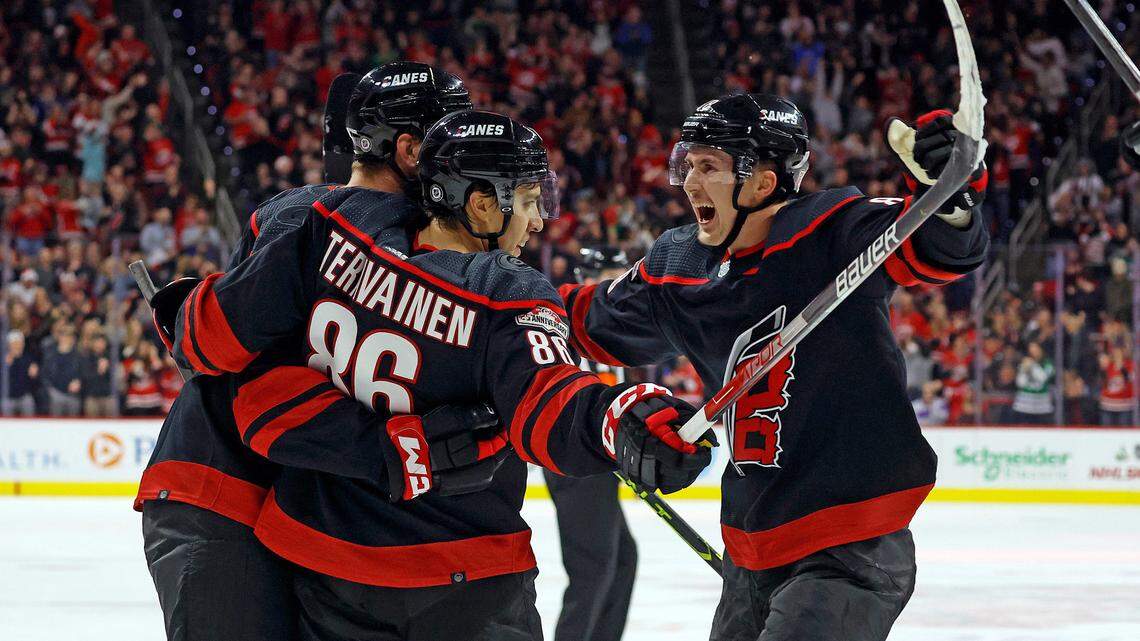 Carolina Hurricanes’ Teuvo Teravainen (86) celebrates his goal with teammates Brent Burns, and Martin Necas, right, during the second period of an NHL hockey game against the Dallas Stars in Raleigh, N.C., Saturday, Dec. 17, 2022. (AP Photo/Karl B DeBlaker)
