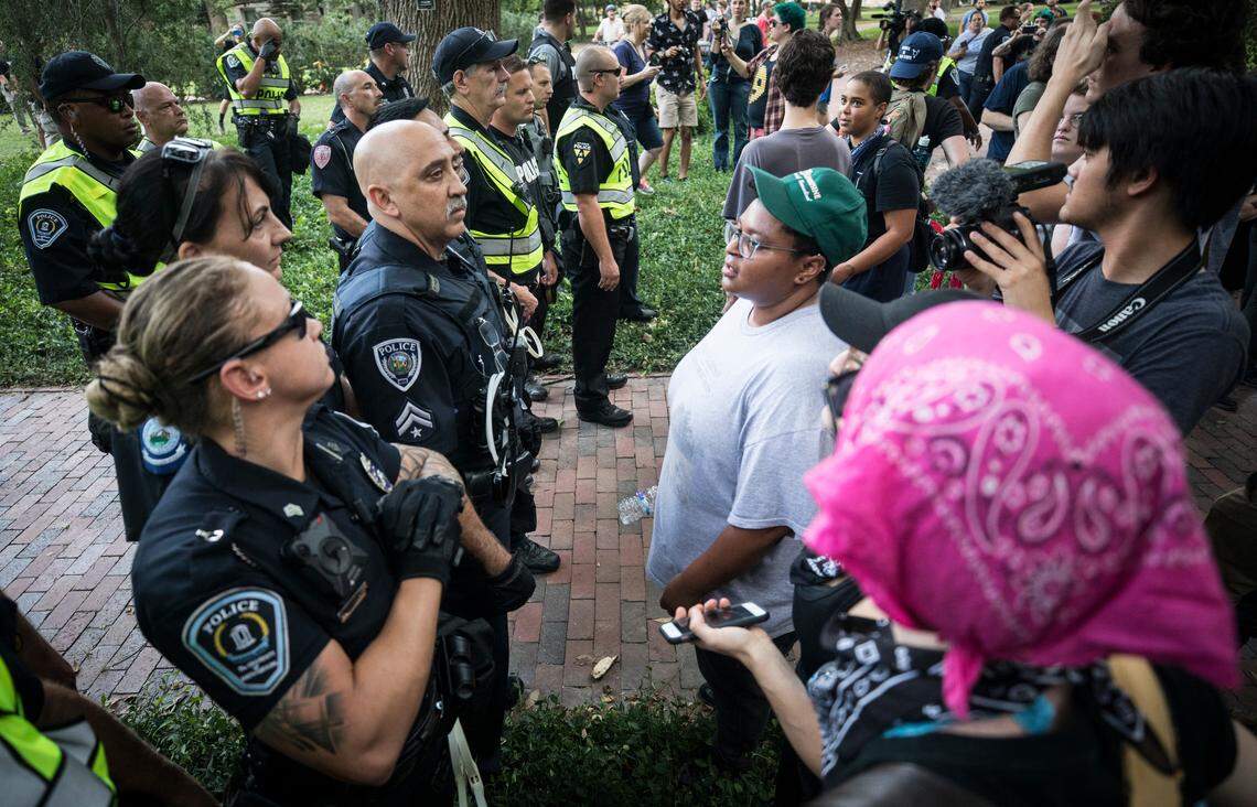Police officers face off with students and protesters after pro-Confederate demonstrators were escorted off campus on Saturday, September 8, 2018.