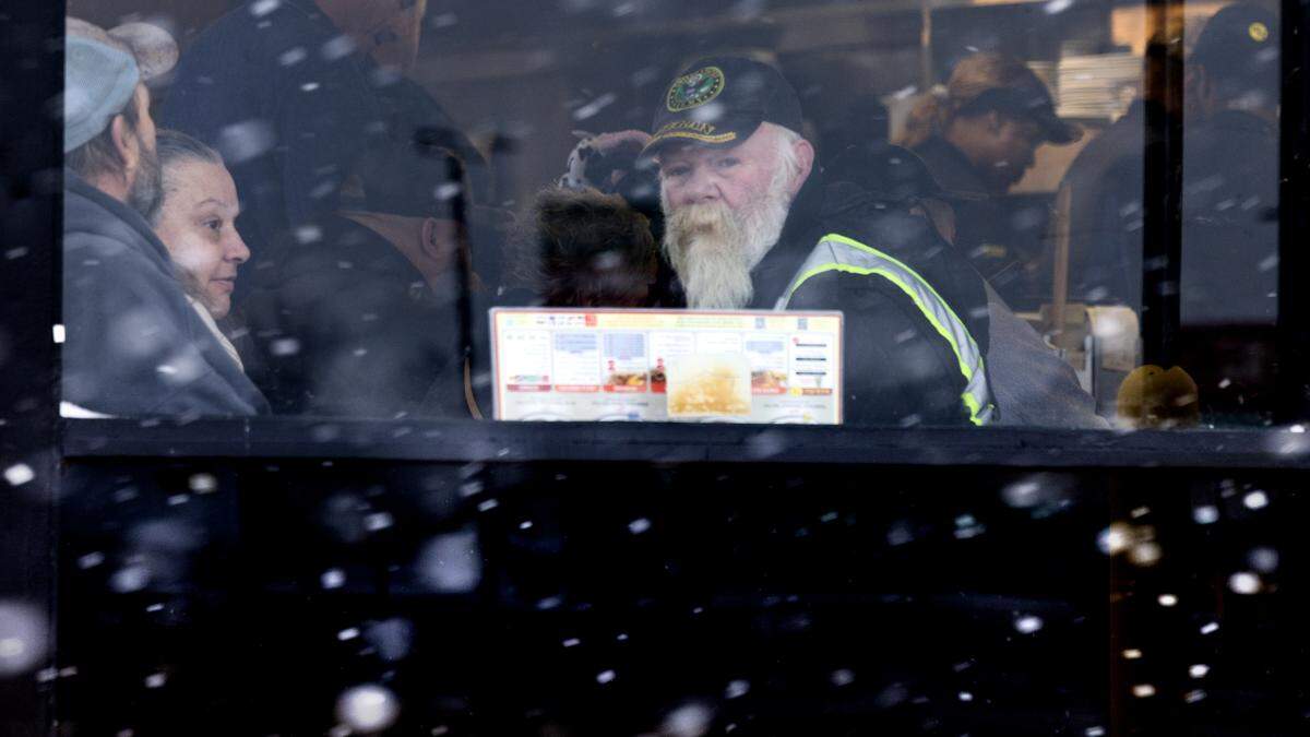 Diners at the Waffle House in Kenly watch the snow fall mid-morning in Johnston County.
