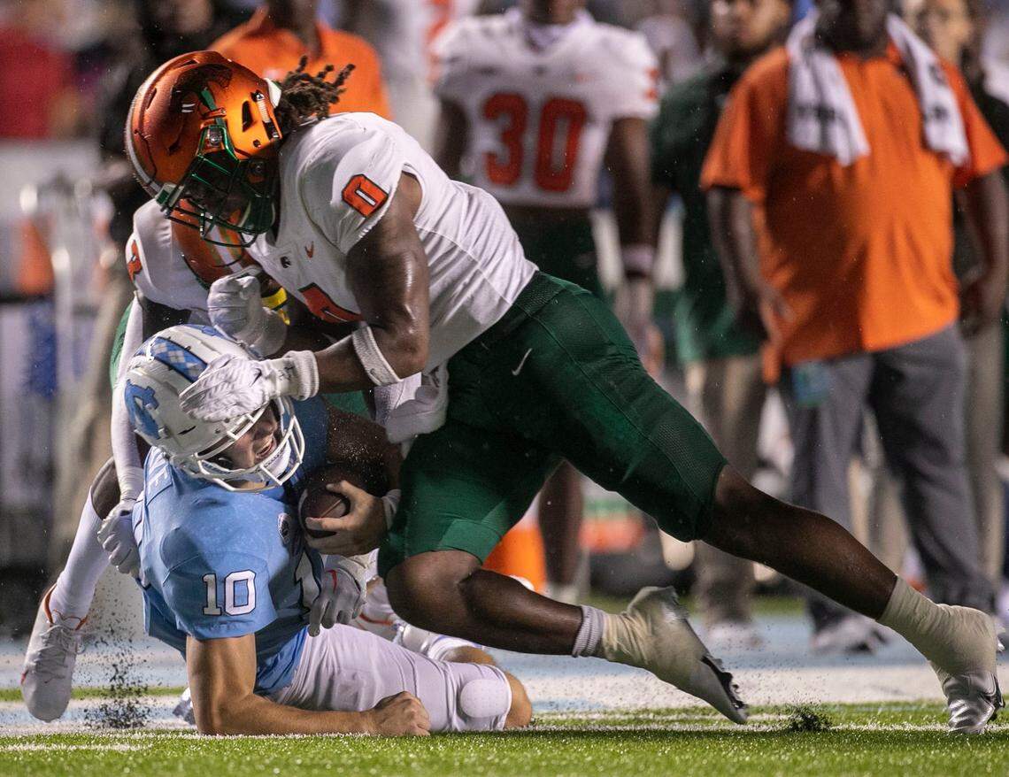 North Carolina quarterback Drake Maye (10) takes a hit from Florida A&M linebacker Isaiah Major (0) after a 42-yard gain in the first quarter on Saturday, August 27, 2022 at Kenan Stadium in Chapel Hill, N.C.