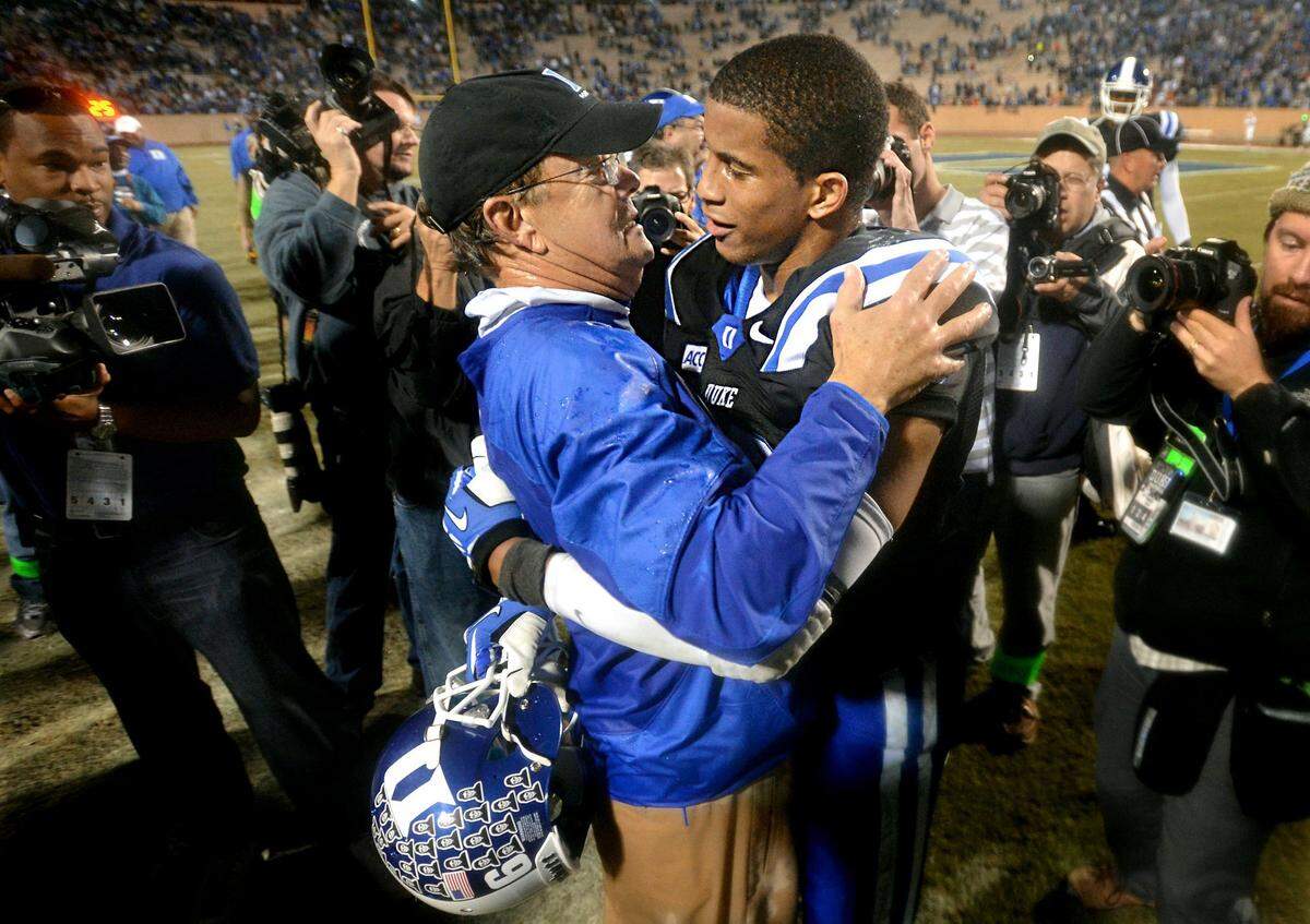 Duke head coach David Cutcliffe hugs safety Jeremy Cash at the end of the Miami game. Cash was named a member of the 2013 All-ACC Football Team defensive first team. Cash has brought a toughness to the back end of Duke’s secondary. He leads Duke with 4 INTs, and is second on team in tackles with 109.