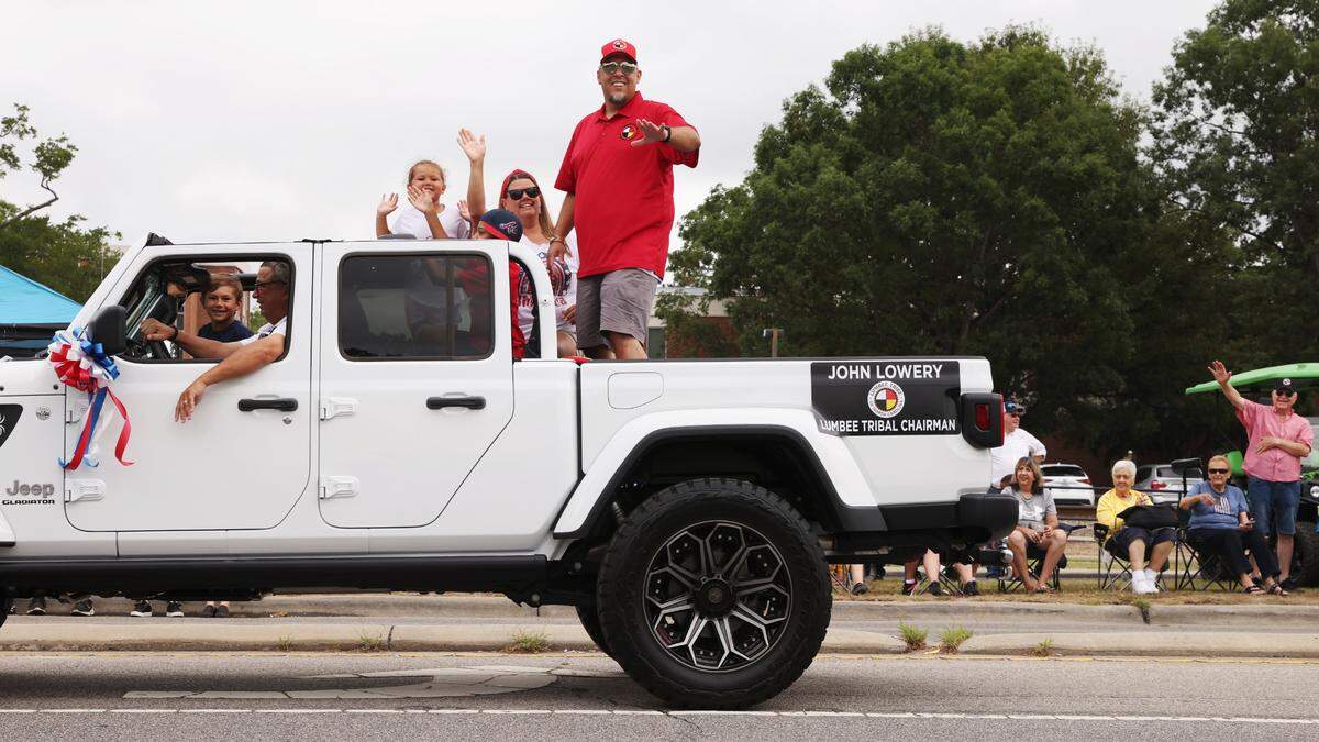 Lumbee Tribal Chairman John Lowery waves to supporters at a parade during the annual Lumbee Homecoming in Pembroke in 2022. The Lumbee tribe of Eastern North Carolina has been fighting for full federal recognition for decades.