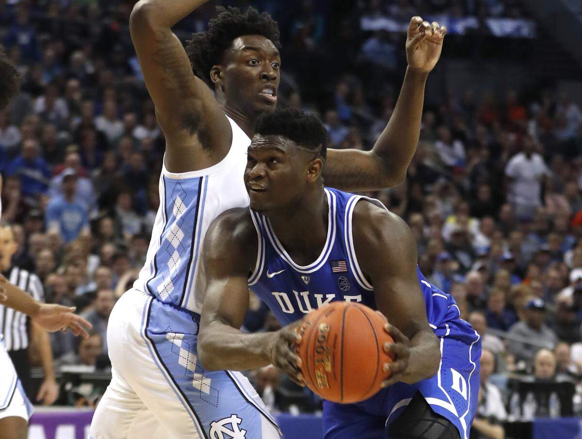 Duke’s Zion Williamson (1) drives around North Carolina’s Nassir Little (5) in a 2019 ACC tournament game in Charlotte. Duke won, 74-73.