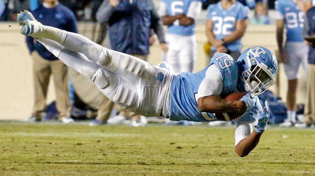 Dazz Newsome (19) hauls in a pass against Western Carolina in 2017.