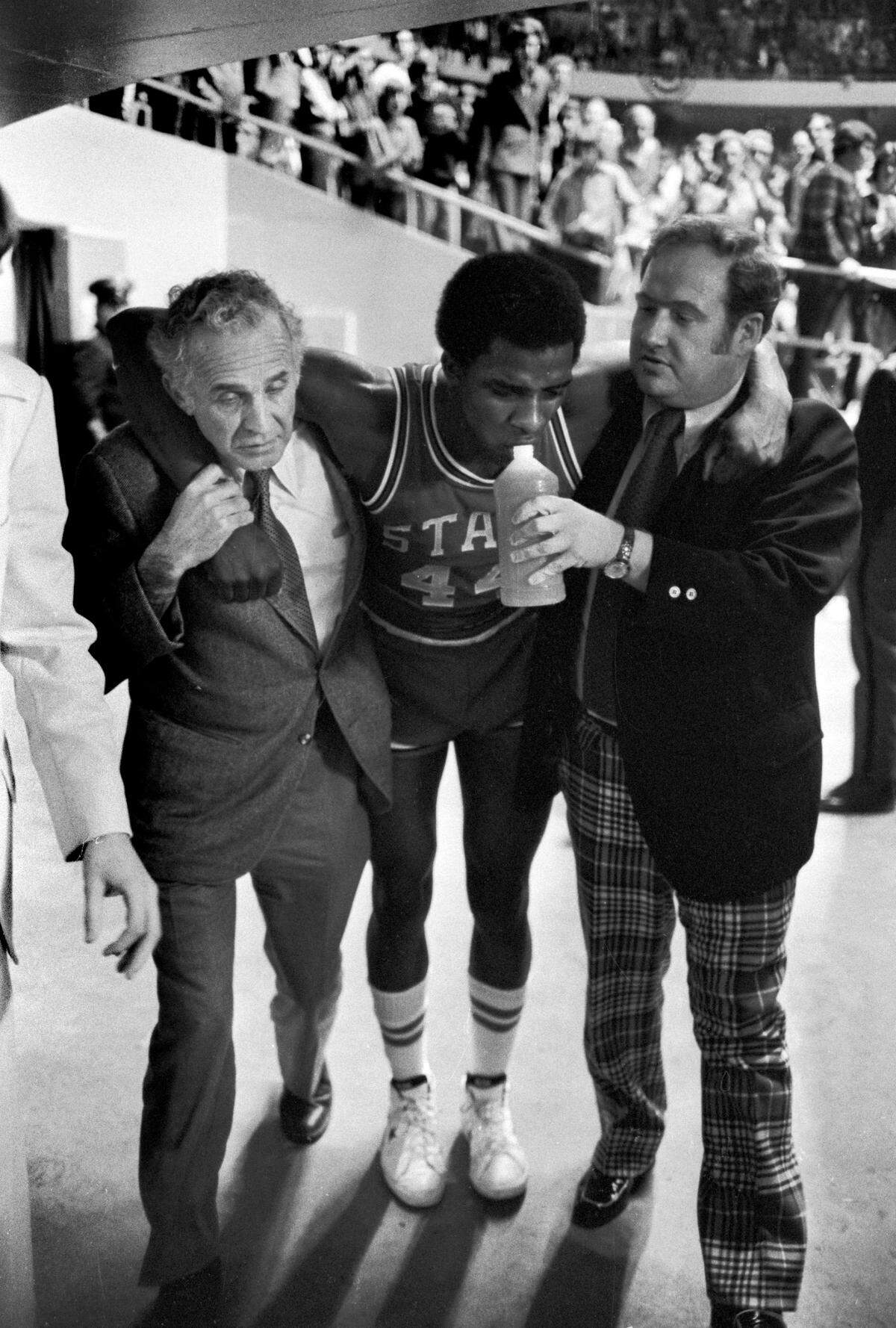 NC State’s David Thompson is helped to the locker room after leaving the 1975 ACC Tournament game against Maryland with severe cramps.