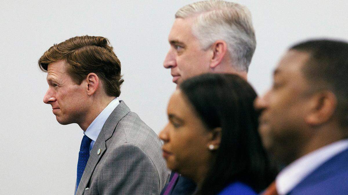 UNC-Chapel Hill Interim Chancellor Lee Roberts, left, listens during a meeting of the UNC System Board of Governors on Thursday, May 23, 2024, in Raleigh, N.C. East Carolina University Chancellor Philip Rogers is to Roberts’ left.