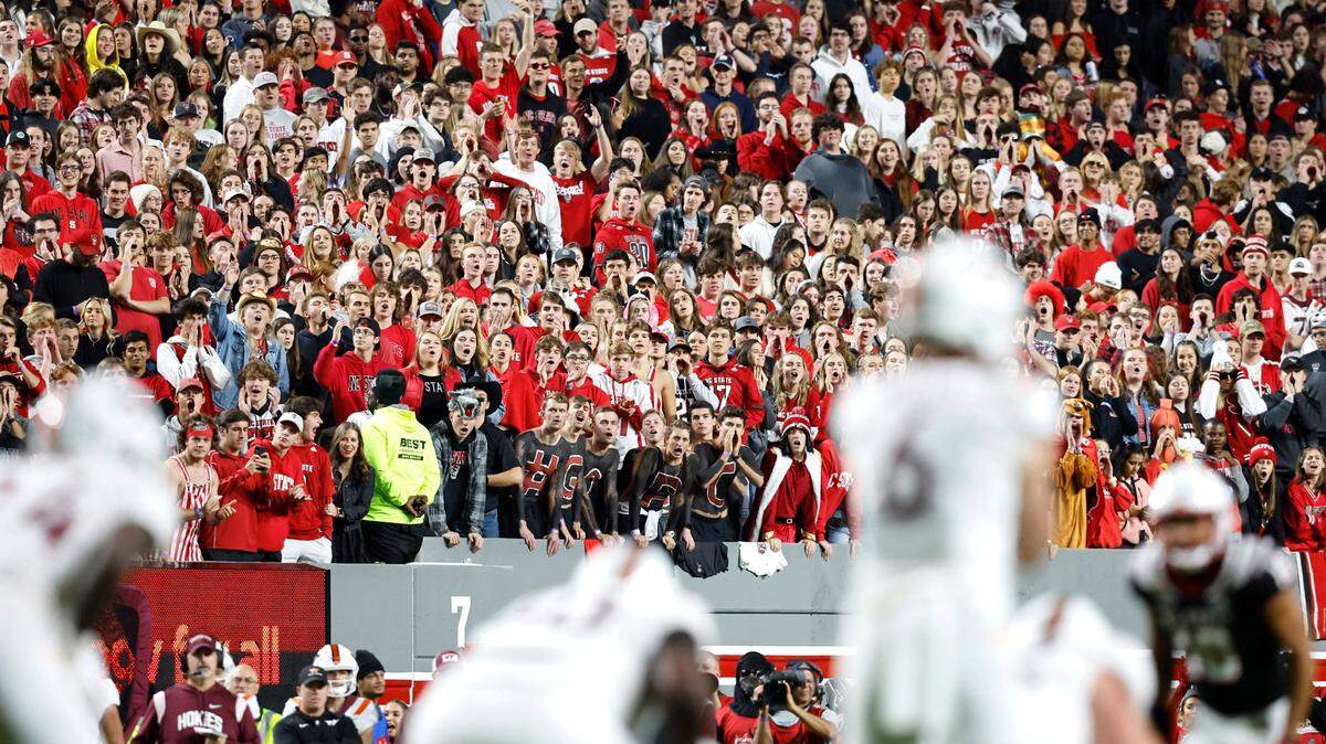 Fans try to disrupt Virginia Tech during the first half of N.C. State’s game against Virginia Tech at Carter-Finley Stadium in Raleigh, N.C., Thursday, Oct. 27, 2022.