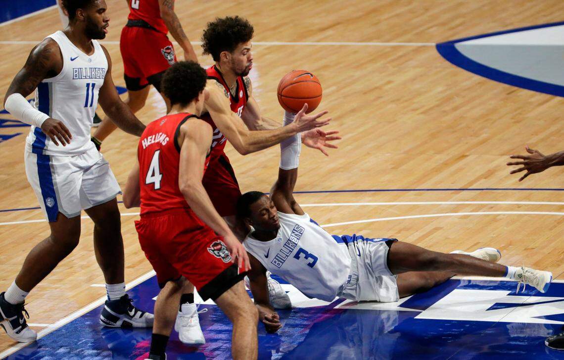 Saint Louis guard Javonte Perkins (3) tries to keep possession of the ball with pressure from North Carolina State guard Devon Daniels (24) during the first half of an NCAA college basketball game, Thursday, Dec. 17, 2020, in St. Louis.