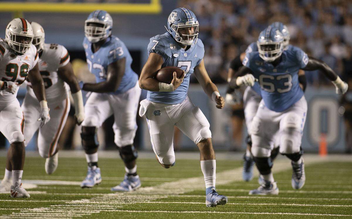 2North Carolina quarterback Sam Howell (7) carries the ball for nine years in first quarter against Miami on Saturday, September 7, 2019 at Kenan Stadium in Chapel Hill, N.C.