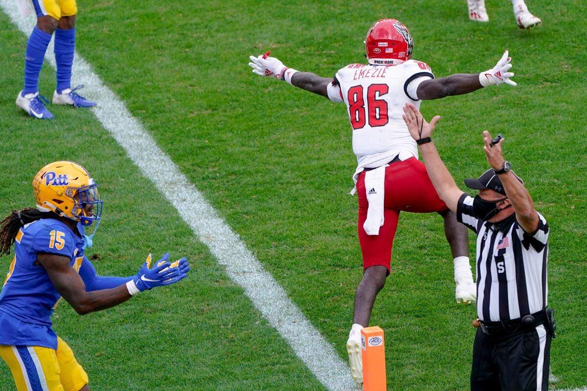 North Carolina State wide receiver Emeka Emezie (86) celebrates after making a touchdown catch in front of Pittsburgh Panthers defensive back Jason Pinnock (15) during the second half of an NCAA college football game, Saturday, Oct. 3, 2020, in Pittsburgh. North Carolina State won 30-29.