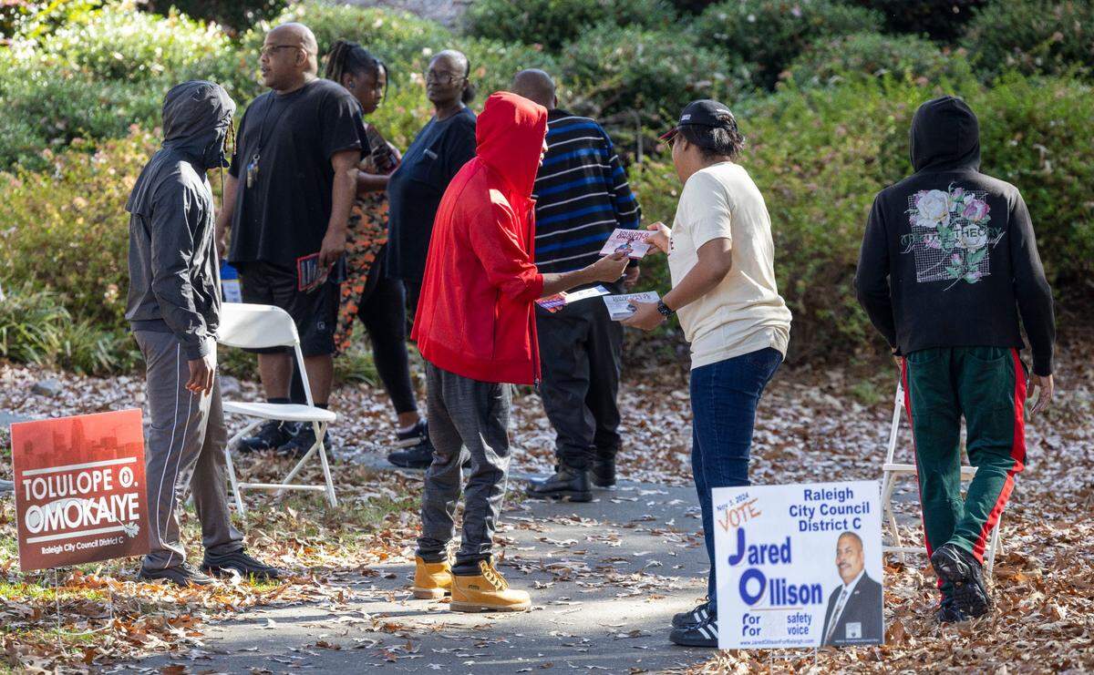 Tamara Purdie hands out literature for Raleigh City Council candidate Tolulope Omokaiye to voters as they arrive to cast their ballots at the Worthdale Community Center on Tuesday, November 5, 2024 in Raleigh, N.C.