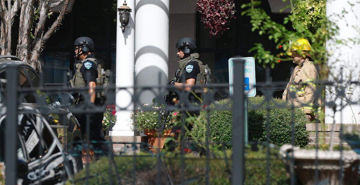 Police and fire personnel walk outside the Siena Hotel in Chapel Hill, N.C., Friday morning, August 22, 2025.