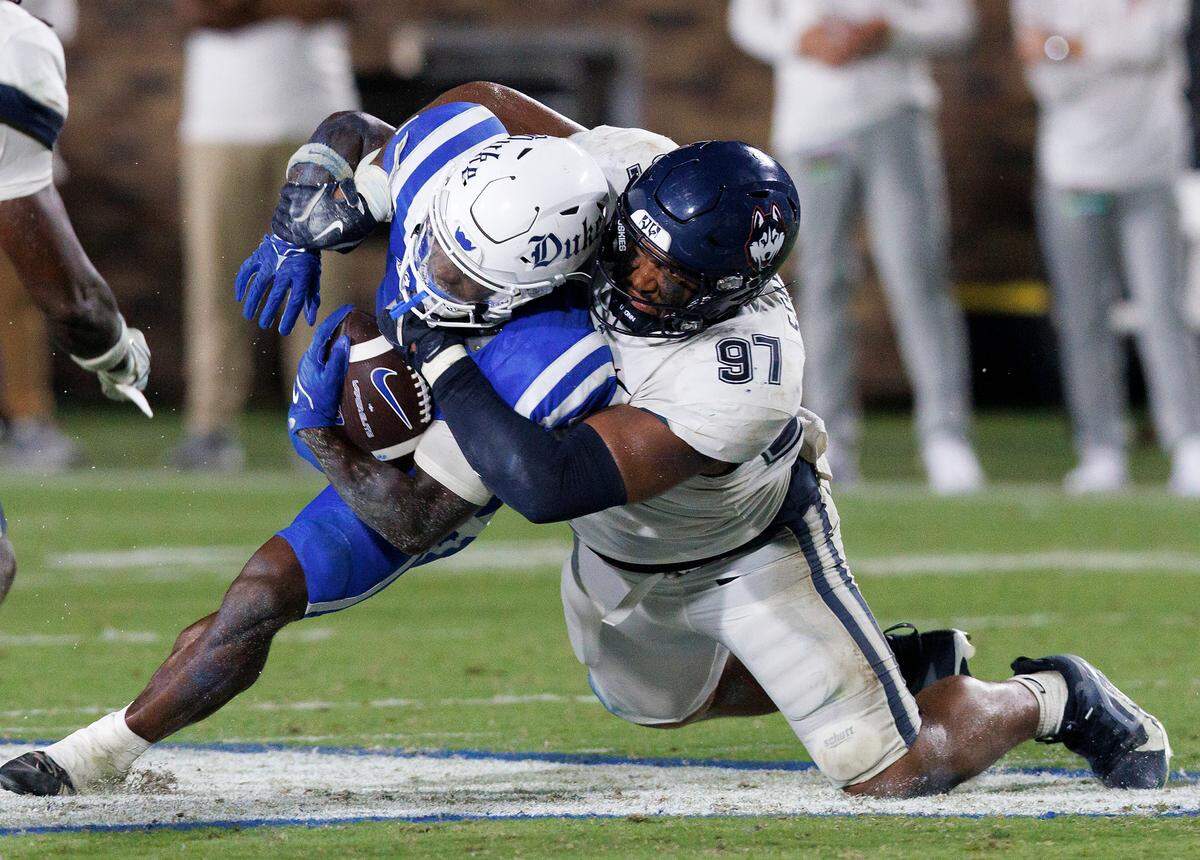 Duke’s Peyton Jones is tackled by Connecticut’s Jelani Stafford during the second half of the Blue Devils’ 26-21 win on Saturday, Sept. 14, 2024, at Wallace Wade Stadium in Durham, N.C.