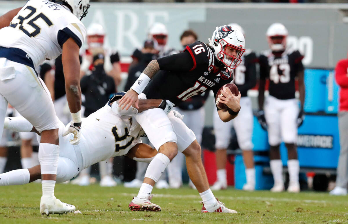 Georgia Tech defensive lineman Kyle Kennard (31) sacks N.C. State quarterback Bailey Hockman (16) during the first half of N.C. State’s game against Georgia Tech at Carter-Finley Stadium in Raleigh, N.C., Saturday, Dec. 5, 2020.